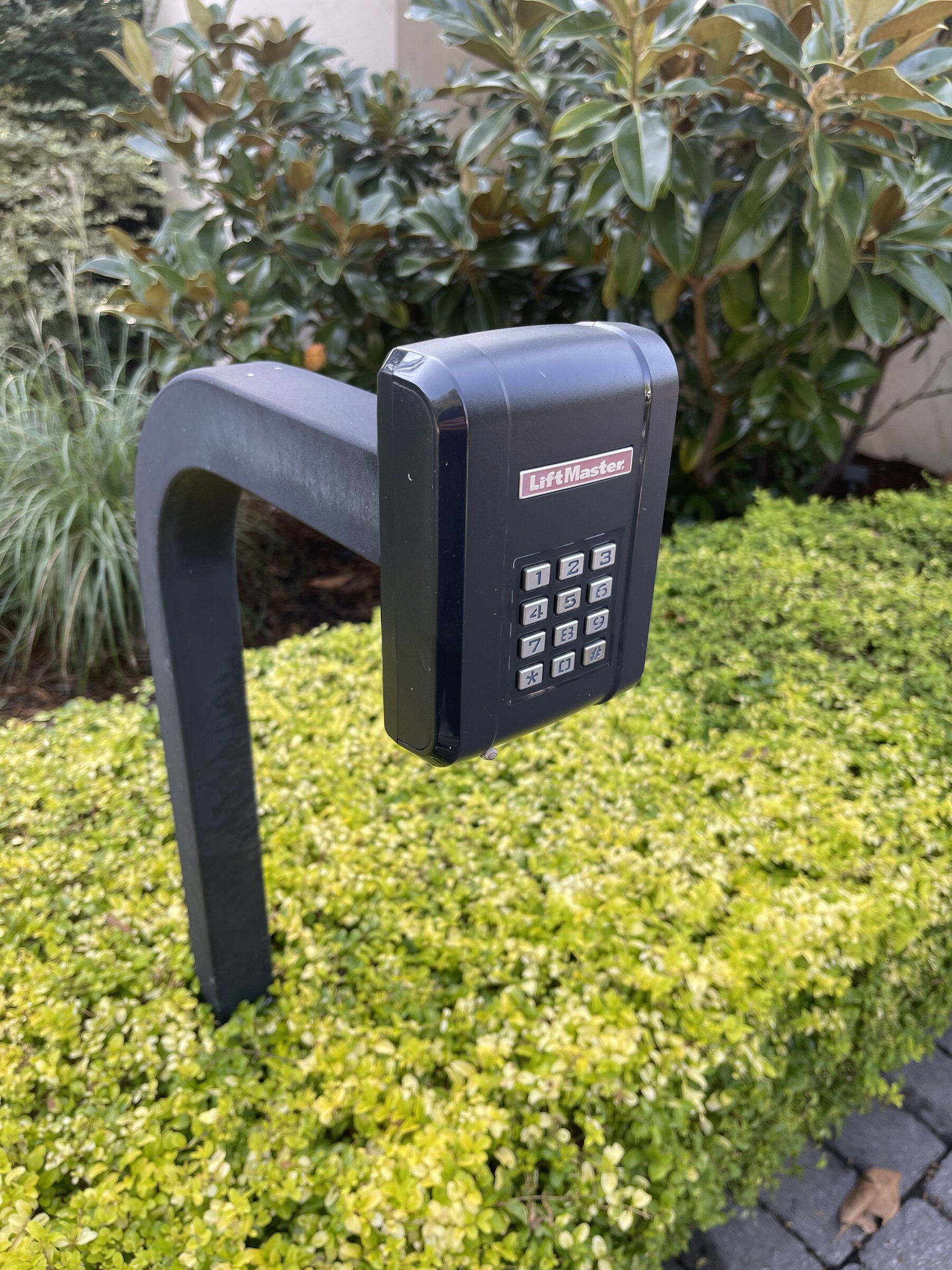 Keypad entry system mounted at a gated driveway