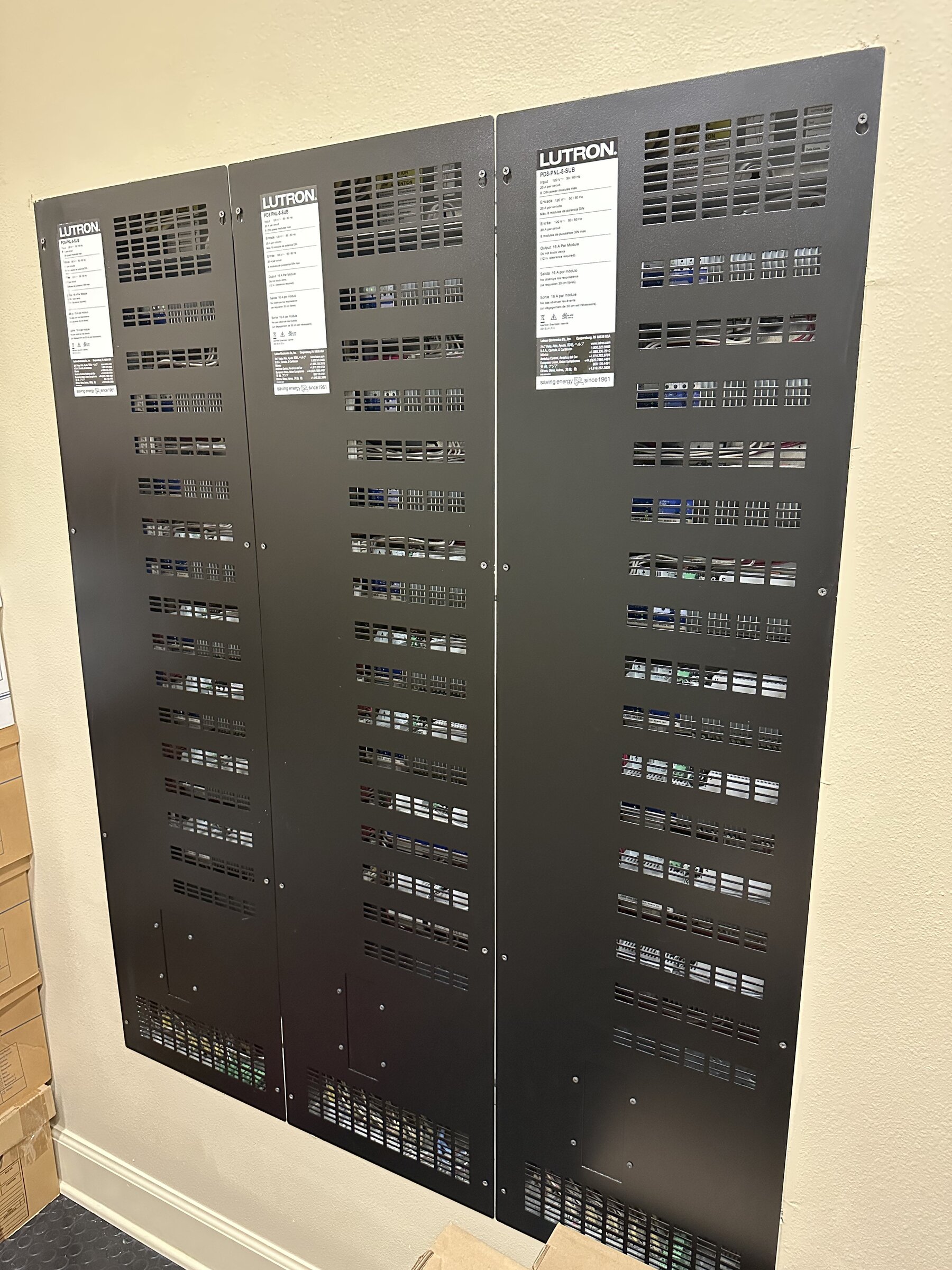 Bank of Lutron lighting processors, professionally installed and labeled