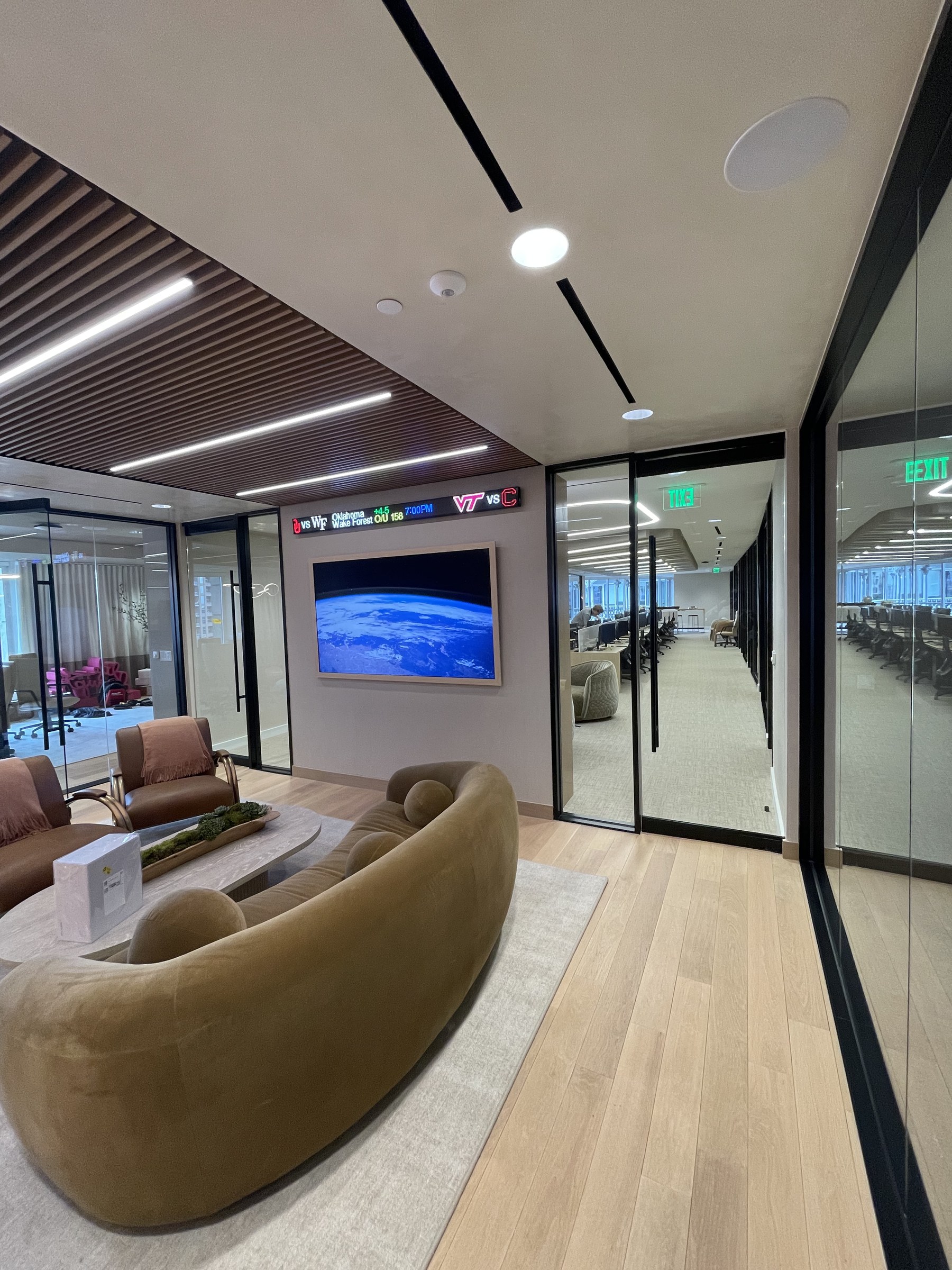 Integrated television and ceiling speakers in a corporate office lounge