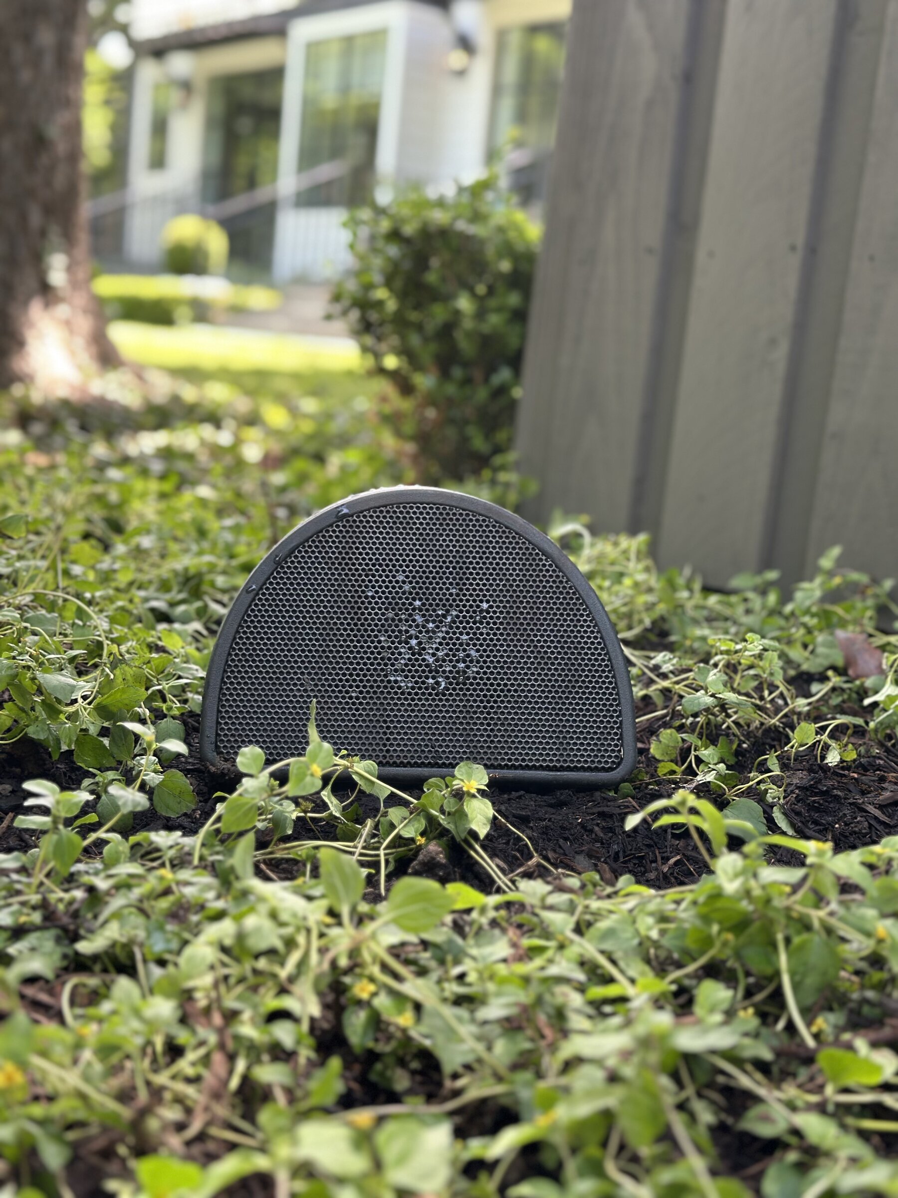 Discreet outdoor landscape speaker set into a garden bed
